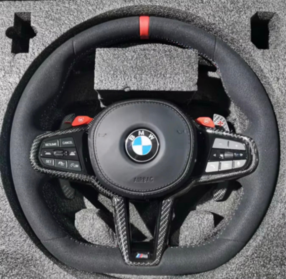 BMW custom steering wheel with controls on a textured surface